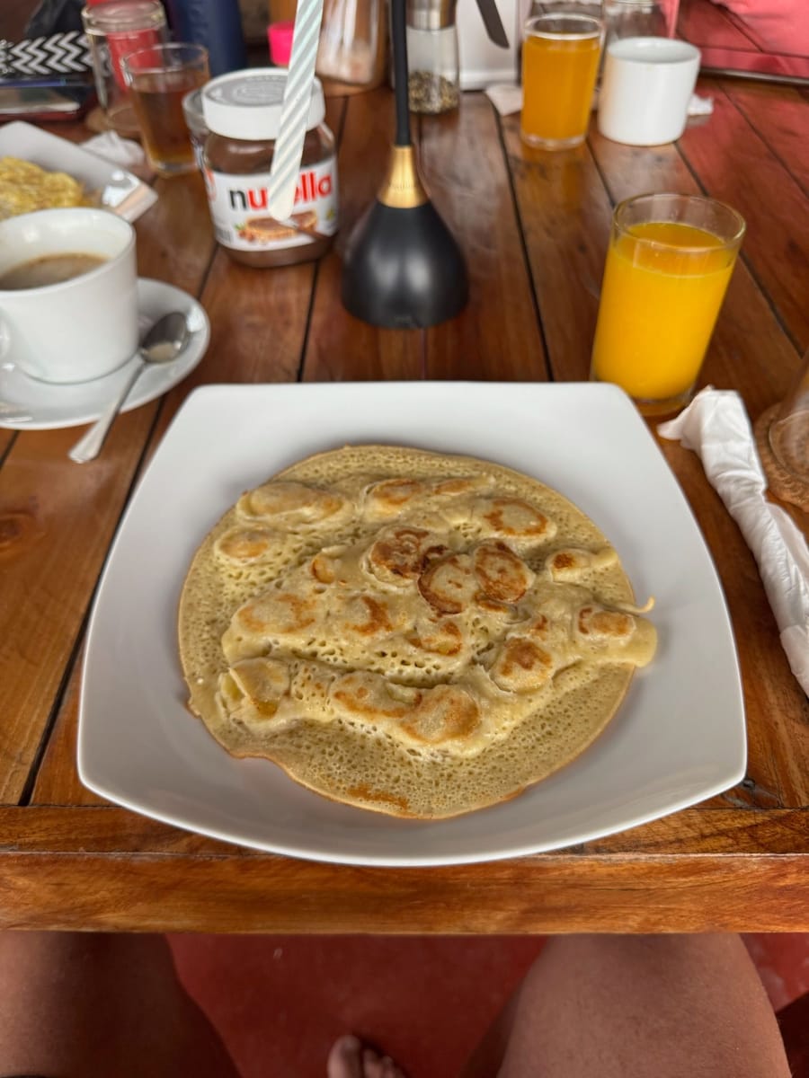 Breakfast at Shamar: a pancake, orange juice and coffee